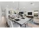 Modern dining room with a large table and a view into the living area at 682 E Aurora Dr, San Tan Valley, AZ 85140