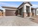 New construction home with a brown garage door and a paved driveway at 682 E Aurora Dr, San Tan Valley, AZ 85140