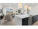 Open concept kitchen with island, looking into living room at 682 E Aurora Dr, San Tan Valley, AZ 85140