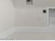 Bright laundry room with white cabinets and flooring at 682 E Aurora Dr, San Tan Valley, AZ 85140