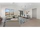 Bright living room features an open floor plan, hardwood floors, and a dining area at 682 E Aurora Dr, San Tan Valley, AZ 85140