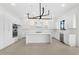 Modern kitchen with white cabinets, marble countertops and stainless steel appliances at 42131 N Golden Trl, San Tan Valley, AZ 85140