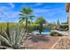 Desert landscaping with a sparkling pool and patio at 5221 E Thunder Hawk Rd, Cave Creek, AZ 85331