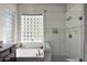 Spa-like bathroom with soaking tub, glass shower, and a large window at 5221 E Thunder Hawk Rd, Cave Creek, AZ 85331