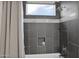 Clean shower stall with gray tile and built-in shelf at 5221 E Thunder Hawk Rd, Cave Creek, AZ 85331