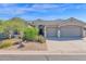 Single-story home with two-car garage and desert landscaping at 5221 E Thunder Hawk Rd, Cave Creek, AZ 85331