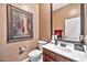 Powder room with single sink vanity and framed art at 29247 N 70Th Ave, Peoria, AZ 85383