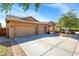 Two-car garage and front entry of tan house at 21527 N 78Th Ln, Peoria, AZ 85382
