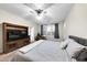 Main bedroom with a king-size bed and an entertainment center at 21527 N 78Th Ln, Peoria, AZ 85382
