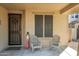 Covered porch with seating, welcome sign, and wreath at 21527 N 78Th Ln, Peoria, AZ 85382