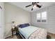 Bright bedroom with a queen bed and wood-paneled wall at 21527 N 78Th Ln, Peoria, AZ 85382
