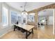 Bright dining area with wood table and stone accent wall at 21527 N 78Th Ln, Peoria, AZ 85382