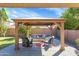Backyard patio with gazebo, seating area, and lush landscaping at 21527 N 78Th Ln, Peoria, AZ 85382