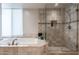 Bathroom with soaking tub, shower, and updated tile work at 11166 E Prospect Point Dr, Scottsdale, AZ 85262