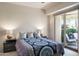 Bright bedroom with a queen-size bed and access to a private patio at 11166 E Prospect Point Dr, Scottsdale, AZ 85262