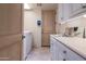 Convenient laundry room with washer, dryer, and extra storage at 11166 E Prospect Point Dr, Scottsdale, AZ 85262