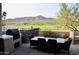 Outdoor patio with mountain views, dining table, and built-in grill at 11166 E Prospect Point Dr, Scottsdale, AZ 85262