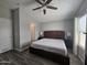 Main bedroom with king bed, ceiling fan and ensuite bathroom at 650 N Hawes Rd # 4409, Mesa, AZ 85207