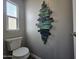 Small bathroom with toilet and unique wall art at 650 N Hawes Rd # 4409, Mesa, AZ 85207