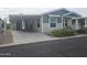House exterior, carport, and landscaped yard at 650 N Hawes Rd # 4409, Mesa, AZ 85207
