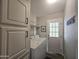Laundry room with washer, dryer, cabinets, and exterior access at 650 N Hawes Rd # 4409, Mesa, AZ 85207