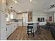Modern kitchen with white cabinets, quartz countertops, and wood-look flooring at 650 N Hawes Rd # 4409, Mesa, AZ 85207