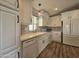 Modern kitchen with white cabinets, white subway tile backsplash and wood-look flooring at 650 N Hawes Rd # 4409, Mesa, AZ 85207
