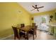 Bright dining area with table and chairs, access to backyard at 21027 N 124Th Ave, Sun City West, AZ 85375