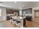 Open concept kitchen with granite island and stainless steel appliances at 269 S 190Th Dr, Buckeye, AZ 85326