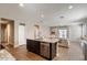Open concept kitchen with island and a view to the living room at 269 S 190Th Dr, Buckeye, AZ 85326