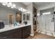 Modern bathroom with double vanity, large shower, and linen storage at 269 S 190Th Dr, Buckeye, AZ 85326