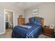 Bedroom with en-suite bathroom and wooden dresser at 269 S 190Th Dr, Buckeye, AZ 85326