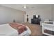 Primary bedroom with king bed, dresser, and view into the living area at 269 S 190Th Dr, Buckeye, AZ 85326