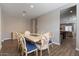 Bright dining room with a table and chairs, and a view into the living area at 269 S 190Th Dr, Buckeye, AZ 85326