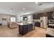 Island kitchen open to living room with stainless steel appliances at 269 S 190Th Dr, Buckeye, AZ 85326