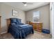 Bedroom with a wooden dresser and blue bedding at 269 S 190Th Dr, Buckeye, AZ 85326