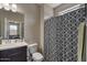 Bathroom with shower/tub combo and patterned shower curtain at 269 S 190Th Dr, Buckeye, AZ 85326