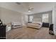 Spacious Primary bedroom with large bed, ceiling fan, and ample natural light at 269 S 190Th Dr, Buckeye, AZ 85326