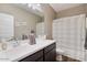 Bathroom with a double vanity and white shower curtain at 269 S 190Th Dr, Buckeye, AZ 85326