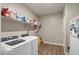 Bright laundry room with washer, dryer, and ample shelving at 269 S 190Th Dr, Buckeye, AZ 85326