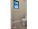 Small half bathroom with toilet and window at 29811 N 154Th St, Scottsdale, AZ 85262