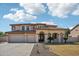 Two-story house with a three-car garage and landscaped front yard at 5213 W Pedro Ln, Laveen, AZ 85339