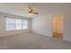 Spacious bedroom with ceiling fan and access to bathroom at 16410 S 46Th Pl, Phoenix, AZ 85048