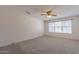 Bright bedroom with ceiling fan and large window at 16410 S 46Th Pl, Phoenix, AZ 85048