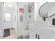 Stylish bathroom with white vanity, round mirror, and built-in shelves at 2233 E Behrend Dr # 210, Phoenix, AZ 85024