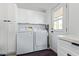 Functional laundry room with Samsung washer and dryer, and cabinets at 2233 E Behrend Dr # 210, Phoenix, AZ 85024