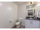 Small half bathroom with white vanity and toilet at 7300 E Earll Dr # 1012, Scottsdale, AZ 85251