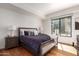 Spacious bedroom with a king-size bed and hardwood floors at 7300 E Earll Dr # 1012, Scottsdale, AZ 85251