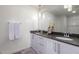 Double vanity bathroom with dark countertop and white cabinets at 7300 E Earll Dr # 1012, Scottsdale, AZ 85251