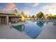 Community pool area with covered patio and lounge chairs at 6711 E Camelback Rd # 21, Scottsdale, AZ 85251